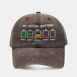 Detail of embroidered battery icons and social battery text on washed grey cotton cap
