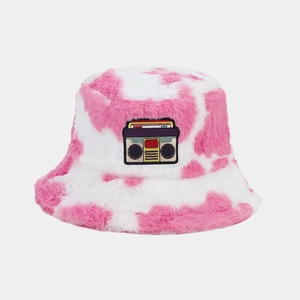 Close-up of pink cow print faux fur bucket hat with vintage cassette tape patch detail