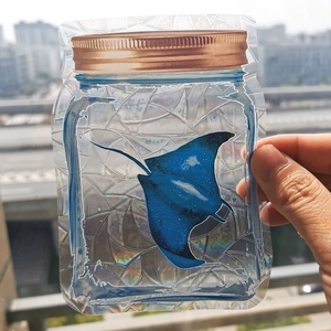 Rainbow suncatcher window sticker featuring a blue manta ray design with prismatic sparkles