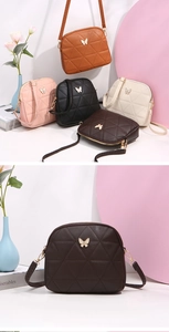 Detail of crossbody shell bag with quilted triangle patterns and golden butterfly decor