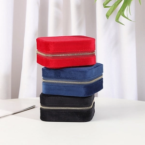 Portable velvet jewelry organizers in red, blue, and black with secure zipper closure