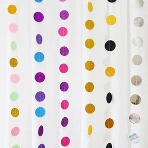 Vertical rows of colorful glitter paper circle garlands for festive party wall decoration