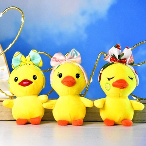Three small plush duck pendants with colorful patterned headbands and bows