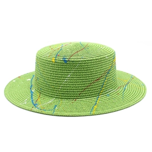 Flat top straw hat in bright grass green with artistic colorful graffiti splatter design