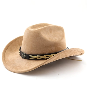 Detail of camel suede cowboy hat featuring leather band and metal bull head emblem