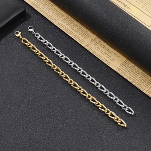 Detailed view of silver and gold curb link chains on a vintage newspaper background