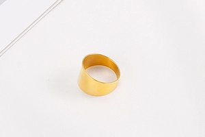 Detailed view of wide gold brushed titanium steel ring with minimalist matte finish
