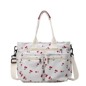 Large white tote bag with red cherry print, multi-pocket design and adjustable strap