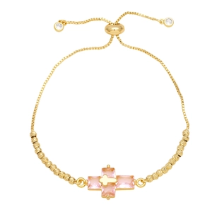 Detail of adjustable gold box chain bracelet with pink gemstone cross charm and beads