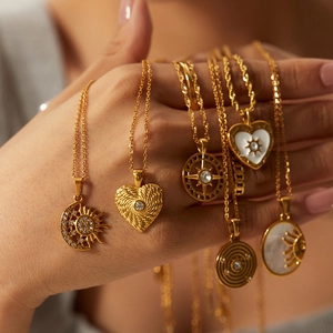 Macro shot of assorted gold-plated celestial and heart pendants on fine link chains