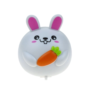 Close-up of Easter bunny figurine with carrot featuring a battery insulation pull tab
