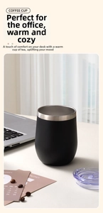 Matte black 12oz stainless steel egg cup on a white office desk with coffee beans