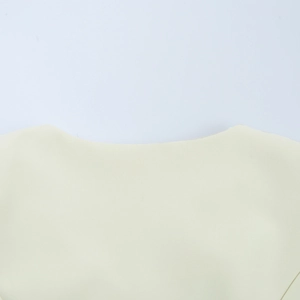 Detailed close-up of a stylish beige neckline featuring smooth woven fabric and precise cut