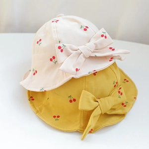 Cute baby sun hats in cream and yellow with cherry patterns and large bows
