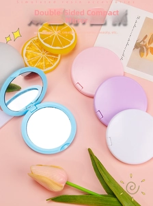 Macro detail of portable macarons colored double-sided folding mirrors set in four shades