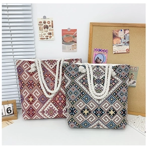 Detail of ethnic embroidered tote bags with thick rope handles and geometric patterns