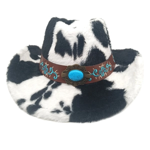 Detail of western cow print cowboy hat with embroidered band and turquoise accent