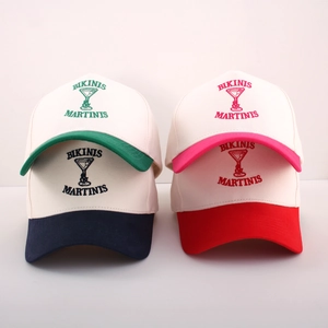 Group display of four embroidered canvas baseball caps with various colorful brims