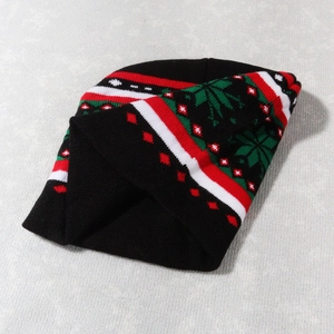 Detailed knit texture of the Christmas beanie with festive red, white, and green patterns