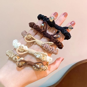 Detail of candy-colored seamless hair ties with elegant bows and crystal bead accents