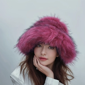 Close-up of fluffy faux fur winter hat in vibrant magenta with thick plush texture