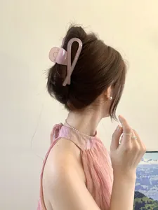 Detail of translucent purple hair claw clip used in an elegant French twist hairstyle