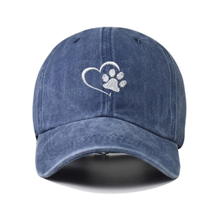 Navy blue washed denim baseball cap featuring white embroidered heart paw on the front