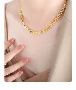 Detailed view of polished 18k gold-plated chunky pig nose link chain necklace on model