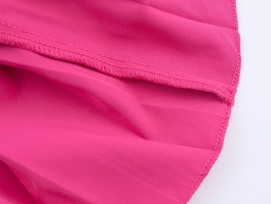Detailansicht der rosa Chenille-Kleid Saumnähte und der hochwertigen Stofftextur