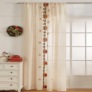 Detail of Christmas lace curtain with red bell embroidery and scalloped edges