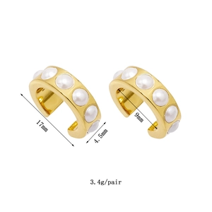 Detailed view of 18K gold plated wide ear cuffs with inset white pearls and dimensions