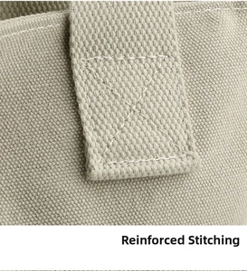 Close-up of reinforced X-shaped stitching on durable canvas shoulder bag handle