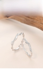 Detail of twisted silver Mobius rings with micro-set zircon on adjustable open band