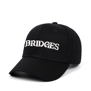Black cotton baseball cap with white BRIDGES embroidery in a 45-degree angle view
