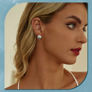 Close-up of elegant blue shell earrings on a model showing natural textures and silver details