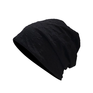 Minimalist black knit slouchy beanie with textured geometric pattern for autumn fashion