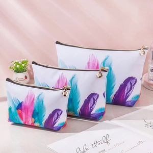 Set of 3 waterproof PU leather makeup bags with vibrant feather prints and gold zippers