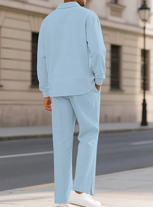 Close-up of light blue waffle knit texture on men's long-sleeve polo shirt and trousers