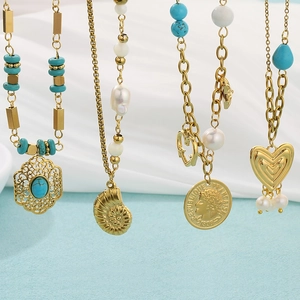 Detailed close-up of 18K gold plated stainless steel necklaces with turquoise and pearls