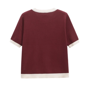 Macro detail of wine red knit top with cream contrast ribbed edges and fine texture