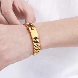 Men's 12mm gold titanium steel Cuban link bracelet with diamond-set plaque on wrist