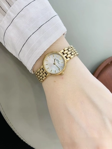 Close-up of golden IBSO mesh watch for women with a white mother of pearl dial on wrist