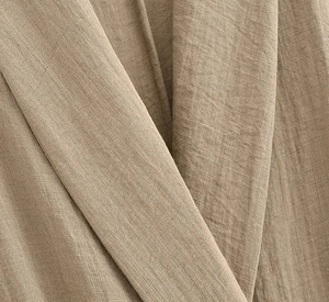 Macro detail of breathable beige linen fabric texture with natural soft wrinkles