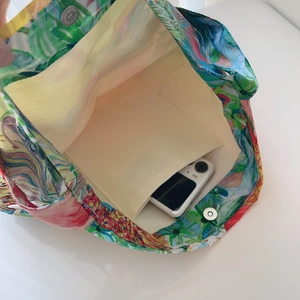 Interior view of floral cotton tote bag showing magnetic buckle and inner pocket