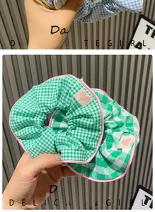 Detail of green gingham scrunchies with pink scalloped edges and a heart-shaped label
