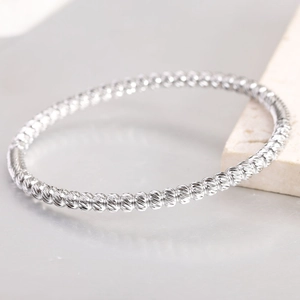 Minimalist 5mm silver stainless steel beaded bracelet with faceted ball texture on marble