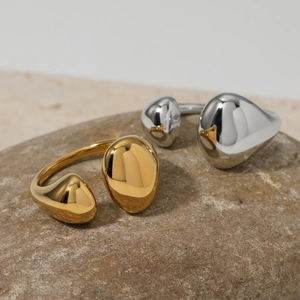 Minimalist irregular open rings in gold and silver finish on natural stone