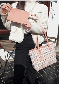 Pink checkered tote bag and matching clutch set shown in a stylish outdoor setting