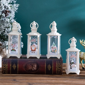Set of 4 vintage ivory Christmas lanterns with Santa and reindeer on rustic books