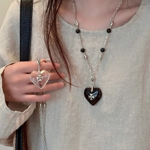 Beaded heart and cross pendant necklace with black beads in a trendy layering style